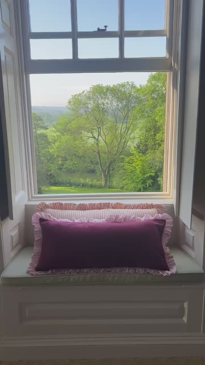Big ruffle pilows on window seat